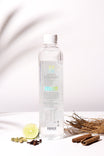 Clear bottle with a label on a white background with herbs and spices.