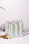 Bottles of Botanica herbal water on a white surface with a light background